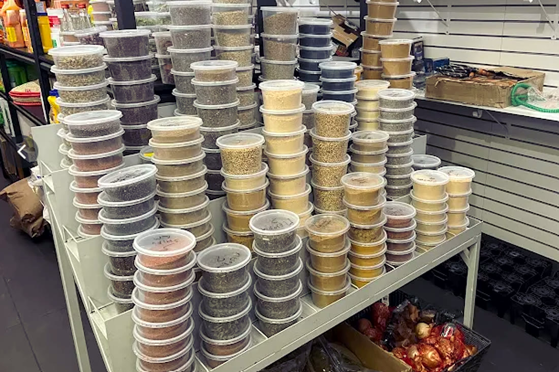 Bulk spices, dried herbs and aromatics in store containers